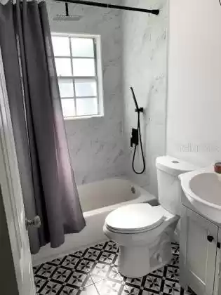 Guest bathroom with dual shower head including rainfall