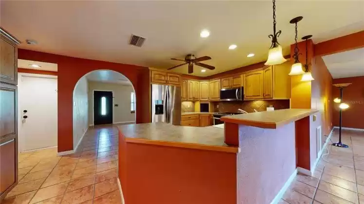 Kitchen with stainless appliances and serving bar