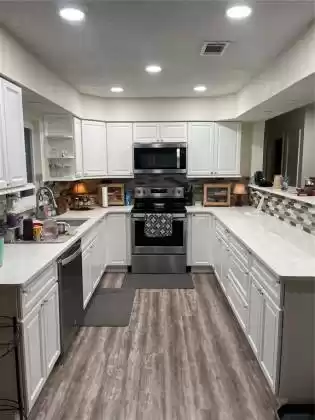 Kitchen with vaulted ceiling and recessed lights