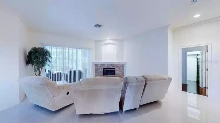 As you enter the home, you are greeted by a beautiful living room complete with a magnificent fireplace and sliding doors that open to the outdoor living space.