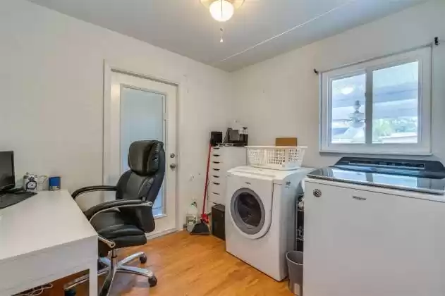 Laundry room with office space. Washer and dryer hookups were installed along with the machines, plus the door access to the garage occurred during the renovation.