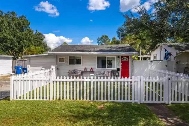 An inviting fenced front yard, front porch and front door!!