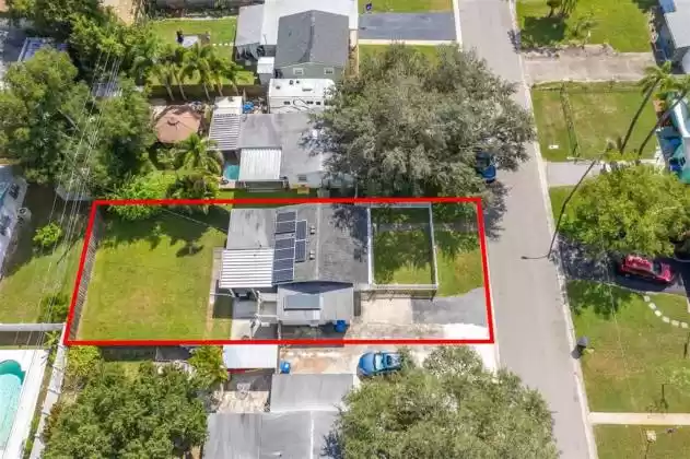 This aerial view shows a nice yard. And notice your solar panels on both the garage and home- Credit every month on your Duke Energy bill!! And remember, those solar panels have already been paid off in full