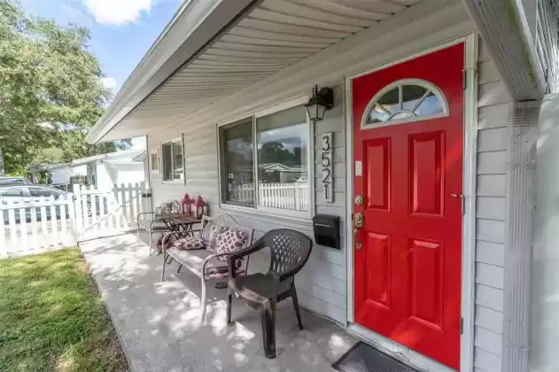 Your red front door!!! And notice the gate at the end of the porch so easy access to yard and front door from driveway. It is one of two gate entries into your front yard