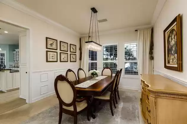A large and spacious dining room has easy access  to the kitchen.